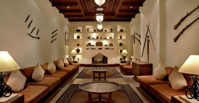 View of the Male Majlis, showing the interior design of the space with bespoke furniture and lighting, and antiques adorning the walls at the Al Maha Desert Resort & Spa designed by RTAE, Dubai